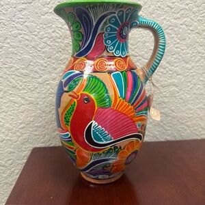 Red and Pink Ceramic Art with Swirling Motifs